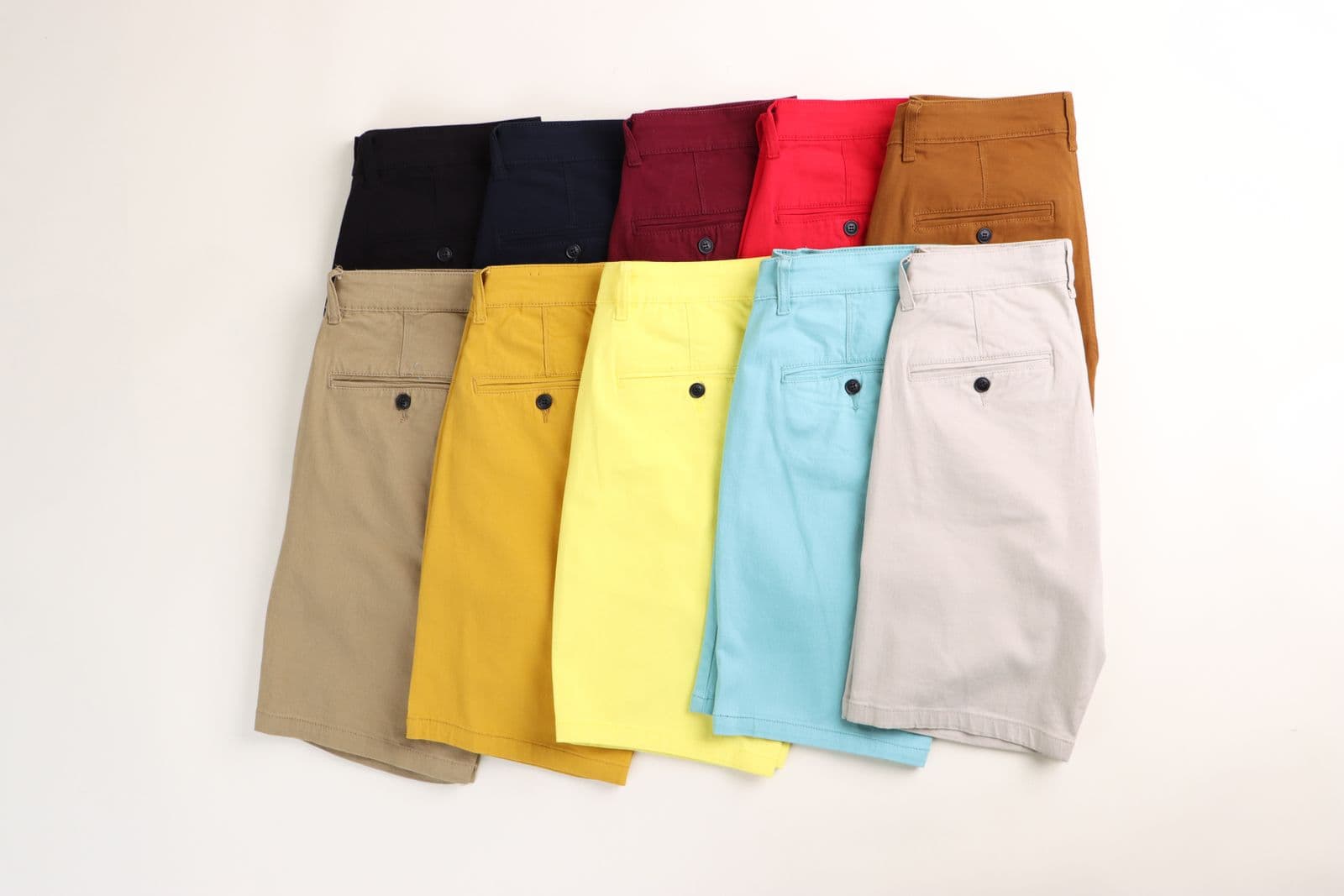 A flat lay of tailored shorts in several colors